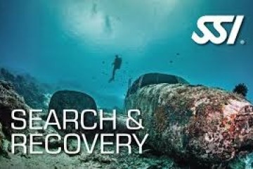 Diver underwater near large rocks with 'Search & Recovery' and 'SSI' text.